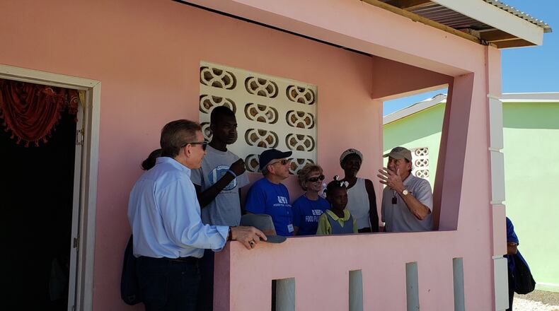 Marie and two of her five children welcomed Piqua resident Boca Grande Hope For Haitians Co-Chairman Ben Scott (right) and Scott's family friends Frank and Julie Gilardi (center), and Food For The Poor Executive Director Angel Aloma (left) to her new home in Savann Kabrit, Haiti. Hope For Haitians built dozens of homes within the community and plans to build an additional 50 homes through Food For The Poor for families like Marie's. (Photo/Food For The Poor) Ben Scott (blue shirt), Co-Chairman of Boca Grande Hope For Haitians, returned to Haiti with Food For The Poor Executive Director Angel Aloma (right) to see the 50 homes built by Hope For Haitians in Savann Kabrit to speak with some of the families. Boca Grande, through Food For The Poor, helped 50 families move out of rickety structures into secure concrete-block homes. (Photo/Food For The Poor)