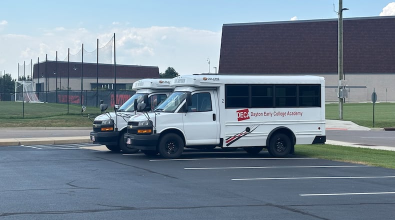 Two buses used to transport Dayton Early College Academy students sit in a lot outside of DECA High School Friday, Aug. 15. Eileen McClory/STAFF