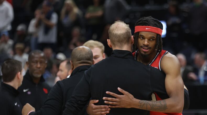 Dayton's DaRon Holmes II hugs Sean Damaska after a loss to Arizona in the second round of the NCAA tournament on Saturday, March 23, 2024, at the Delta Center in Salt Lake City, Utah. David Jablonski/Staff
