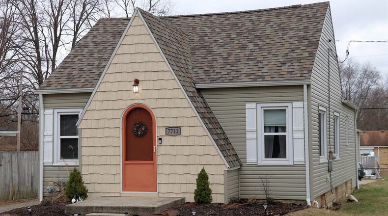 Shake-shingle siding gives character to this vinyl-sided bungalow as the shingles wrap around an arched front door to a triangular peak above the formal entry. The exterior design adds to the charm and lends a preview to the interior updates. Contributed photos by Kathy Tyler
