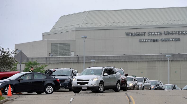 Hundreds of vehicles lined up at the Wright State University Nutter Center July 23 for the Greene County Food distribution. On Wednesday, Aug. 4, a free pop-up coronavirus testing site will be at the Nutter Center. MARSHALL GORBY\STAFF