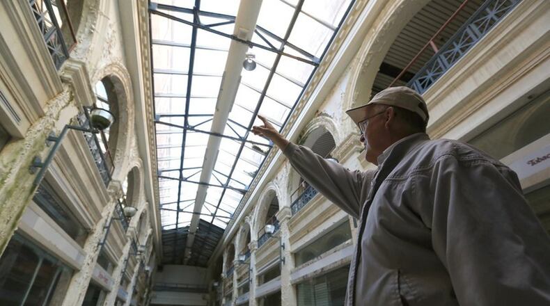 John Gower, CityWide’s urban design director, leads a tour through the Third Street arcade section of the Dayton Arcade. FILE