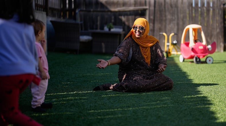 Samsam Khalif plays with children at her home-based child care center Friday, Jan. 30, 2026, in San Diego. (AP Photo/Gregory Bull)