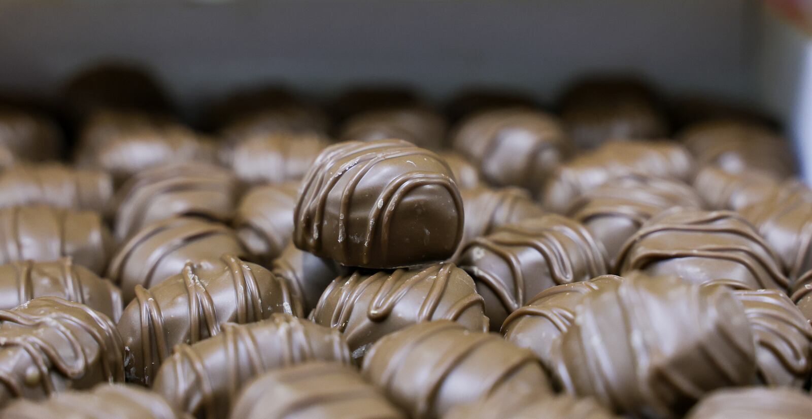 A piece of Esther Price Candy sits atop a stack of others on Tuesday, March 3 at the company's production facility on Wayne Avenue in Dayton. BRYANT BILLING / STAFF