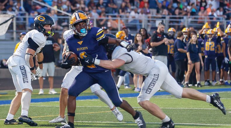 Springfield's Sherrod Lay Jr. (#2) runs toward the end zone as Centerville's AJ Taylor (#6) tries to tackle him during a game on Friday, September 19, 2025, at Springfield High School. JOSEPH COOKE/STAFF