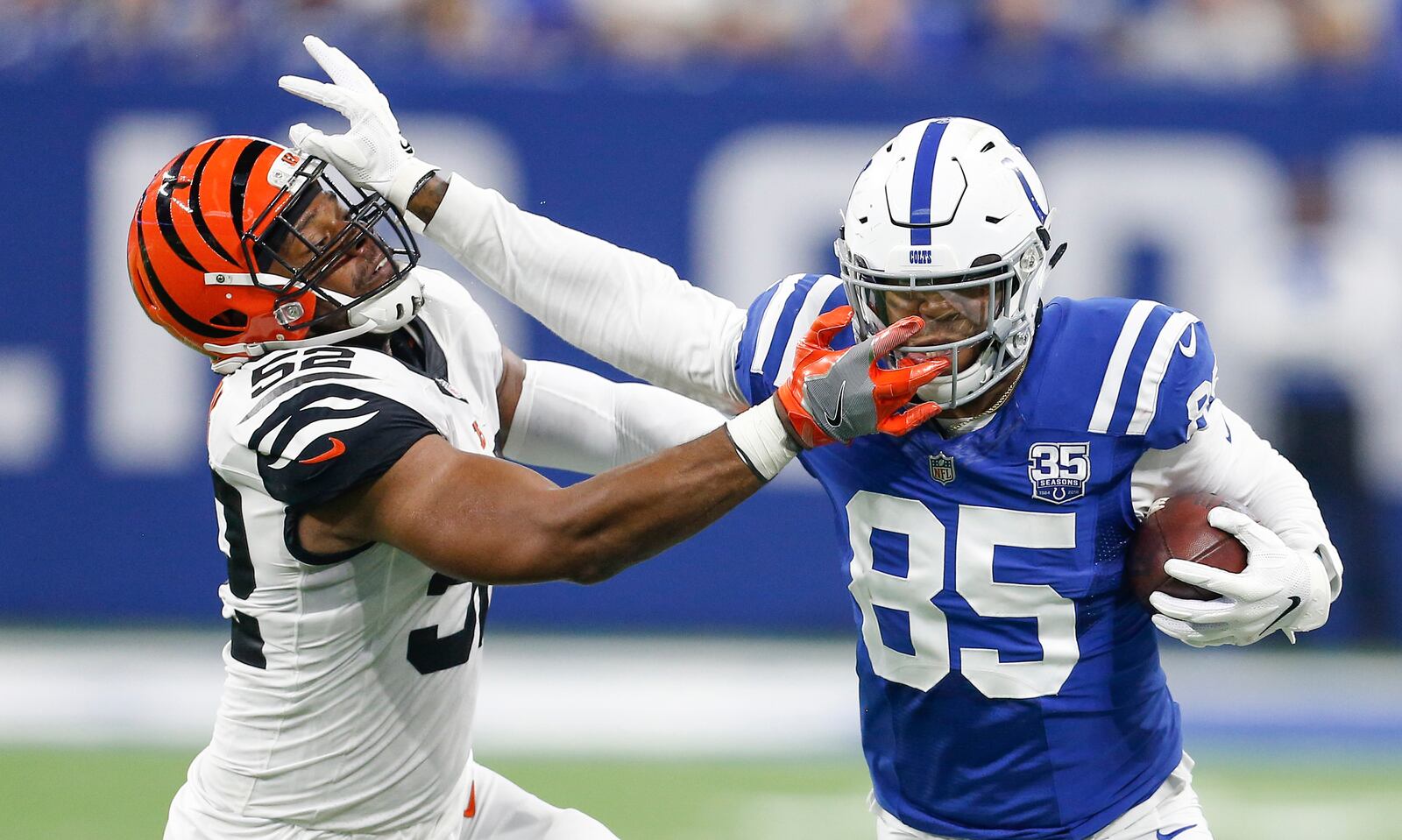 Cincinnati Bengals linebacker Preston Brown (52) tries to bring down Indianapolis Colts tight end Eric Ebron (85) on this first half play on Sunday, Sept. 9, 2018 at Lucas Oil Stadium in Indianapolis, Ind. (Sam Riche/TNS)