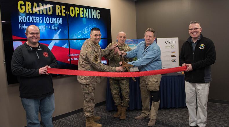 Col. Thomas P. Sherman, 88th Air Base Wing commander, along with Chief Master Sgt. Stephen A. Arbona, 88 ABW command chief, and Bruce Hiott, Wright-Patterson Club general manager, cut the ribbon to open the newly redesigned Rockers Lounge inside the club Feb. 8. The Rocker Lounge is a new area for Airmen and their families to relax in an updated atmosphere. (U.S. Air Force photo/Staff Sgt. Ashley Clingerman)