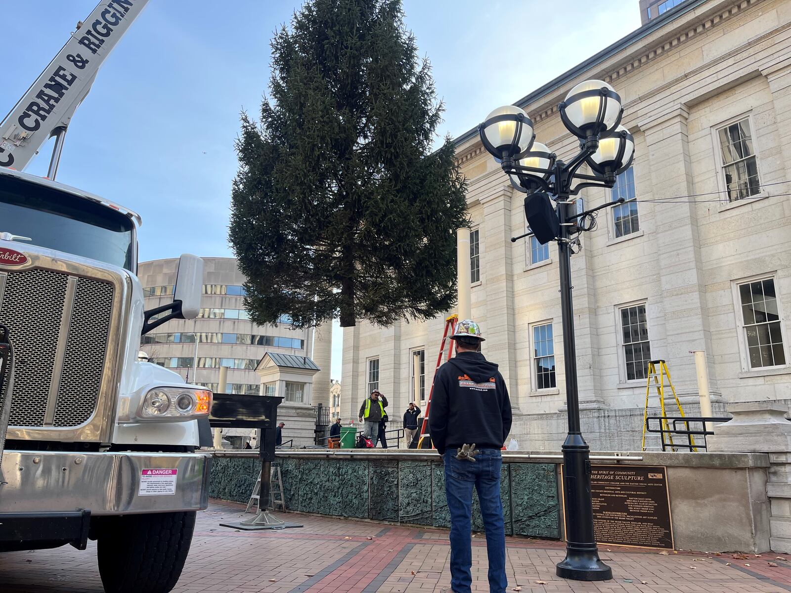 A 35-tall Christmas tree arrived at Courthouse Square on Nov. 8, 2023. The tree will be decorated with lights in coming days, and it will be lit up during the Grande Illumination event on Nov. 24 as part of the Dayton Holiday Festival. CORNELIUS FROLIK / STAFF