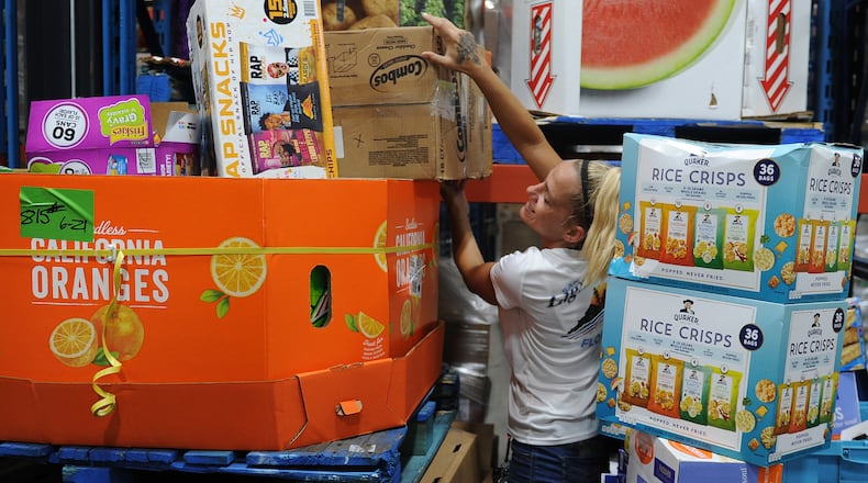 Foodbank employee Carolyn Rife, works in the warehouse Wednesday, June 22, 2022. The Foodbank is getting $3.1 million in aid to help retain their employees. MARSHALL GORBY\STAFF