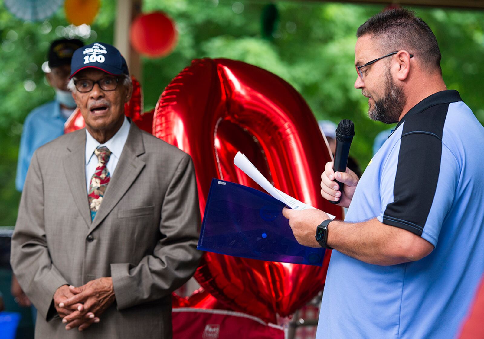 Willie Parker (left), an Air Force veteran who served during World War II and the Korean conflict, reacts as Huber Heights Mayor Jeff Gore reads a proclamation during his 100th birthday celebration July 20 at Thomas A. Cloud Park. U.S. AIR FORCE PHOTO/WESLEY FARNSWORTH