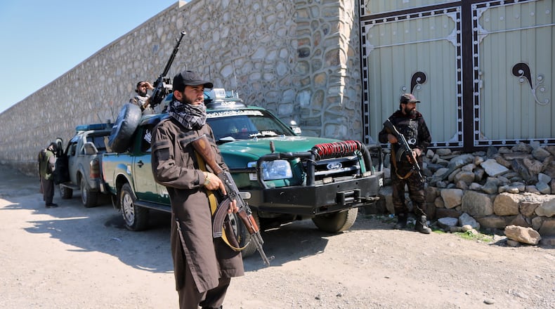 Taliban police guard the area where a strike hit a house in the Momand Dara district of Nangarhar province, Afghanistan, near the border with Pakistan, Friday, March 13, 2026. (AP Photo/Hedayat Shah)