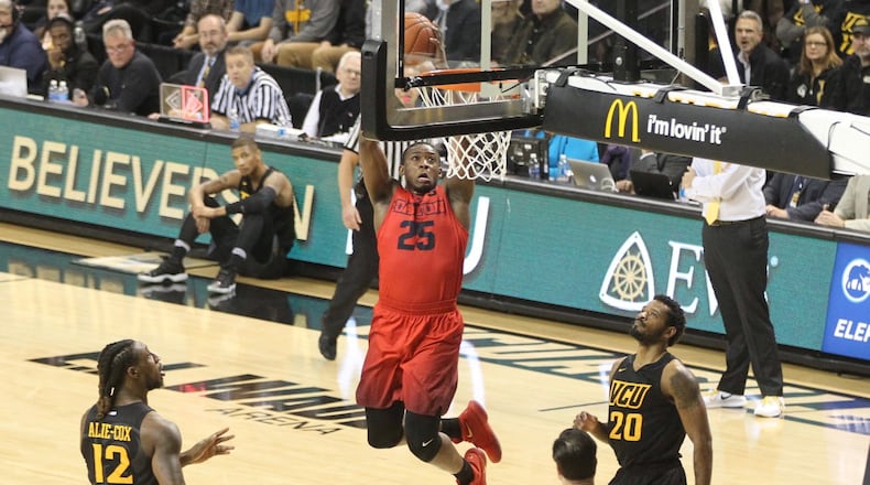 Dayton’s Kendall Pollard dunks against Virginia Commonwealth on Friday, Jan. 27, 2017, at the Siegel Center in Richmond, Va. David Jablonski/Staff
