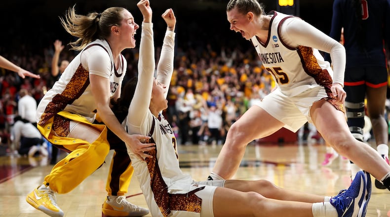 Minnesota guard Amaya Battle, center, celebrates after her winning basket against Mississippi during the second half in the second round of the NCAA college basketball tournament, Sunday, March 22, 2026, in Minneapolis. (AP Photo/Matt Krohn)