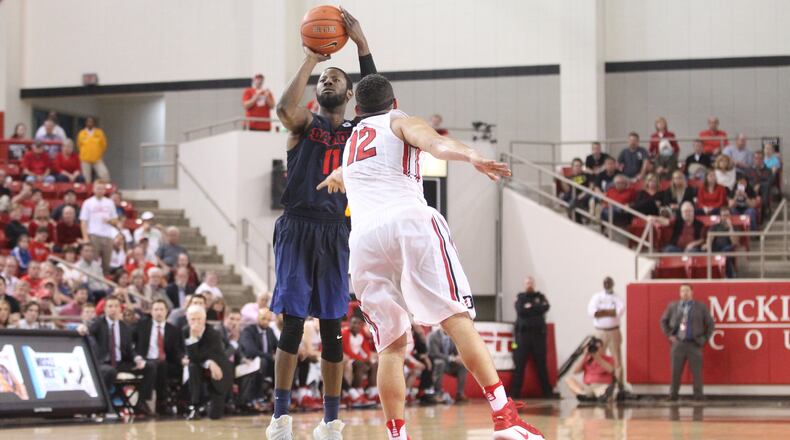 Dayton's Scoochie Smith makes his third straight 3-pointer in overtime in front of Davidson's Jack Gibbs on Friday, Feb. 24, 2017, at Belk Arena in Davidson, N.C.