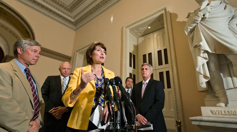 FILE - In this July 17, 2013, file photo Rep. Cathy McMorris Rodgers, R-Wash., center, chair of the House Republican Caucus, and other GOP leaders, meet with reporters just before a vote to delay the individual and employer mandates of President Barack Obama's signature health care law at the Capitol in Washington. At far left is Rep. Fred Upton, R-Mich., chairman of the Committee on Energy and Commerce, second from left at rear is Rep. John Kline, R-Minn., Chairman of the House Education Committee, and at right is House Majority Whip Kevin McCarthy, R-Calif. (AP Photo/J. Scott Applewhite, File)