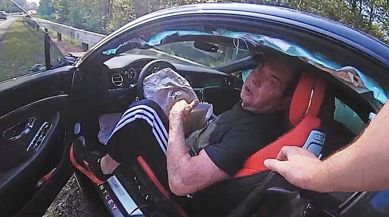 In an image taken from Connecticut State Police police bodycam video, Vince McMahon is questioned in his car after an accident on July 24, 2025, in Westport, Conn. (Connecticut State Police via AP)