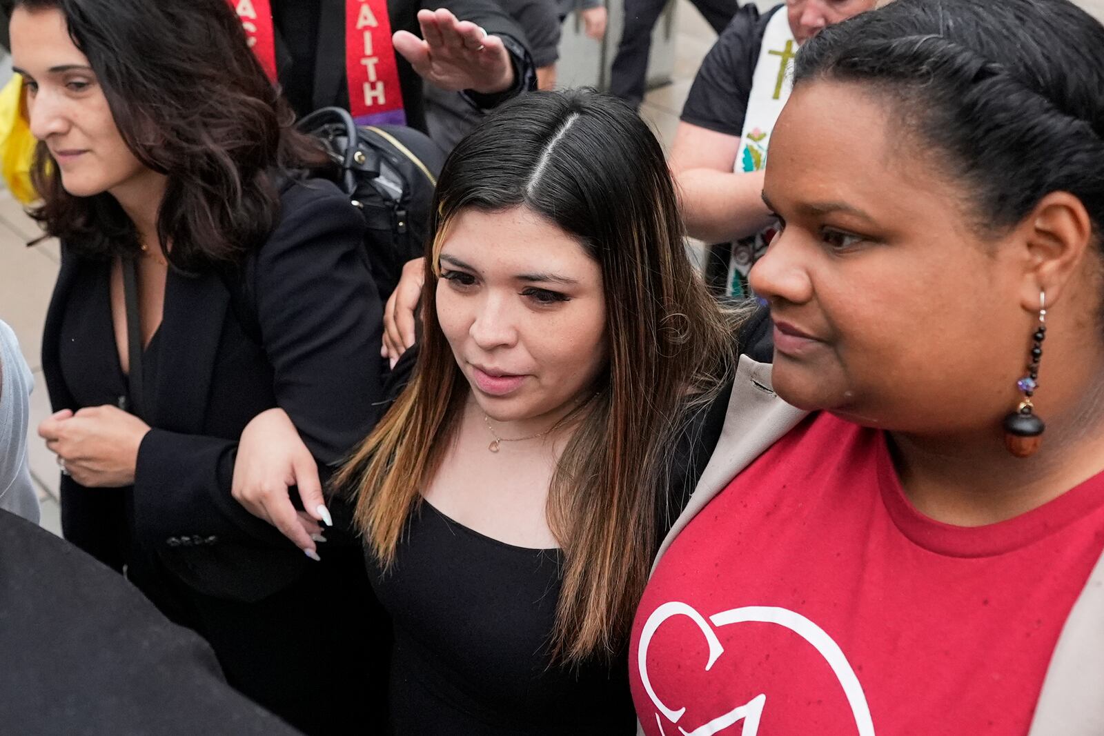Jennifer Vasquez Sura, wife of Kilmar Abrego Garcia, center, is escorted out of the Federal Courthouse on Friday, June 13, 2025, in Nashville, Tenn. (AP Photo/George Walker IV)