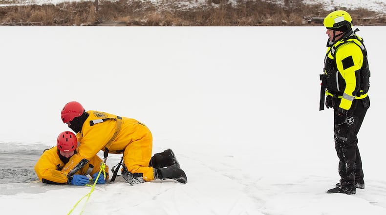 A firefighter with the 788th Civil Engineer Squadron Fire Department at Wright-Patterson Air Force Base places a line around a co-worker playing the role of “victim” under the watchful eye of Fire Department Capt. Brian Wilcher during ice-rescue training Feb. 10. February’s cold snap gave the fire department an opportunity to acclimate its responders to conditions they would encounter in an ice emergency. U.S. AIR FORCE PHOTO/R.J. ORIEZ