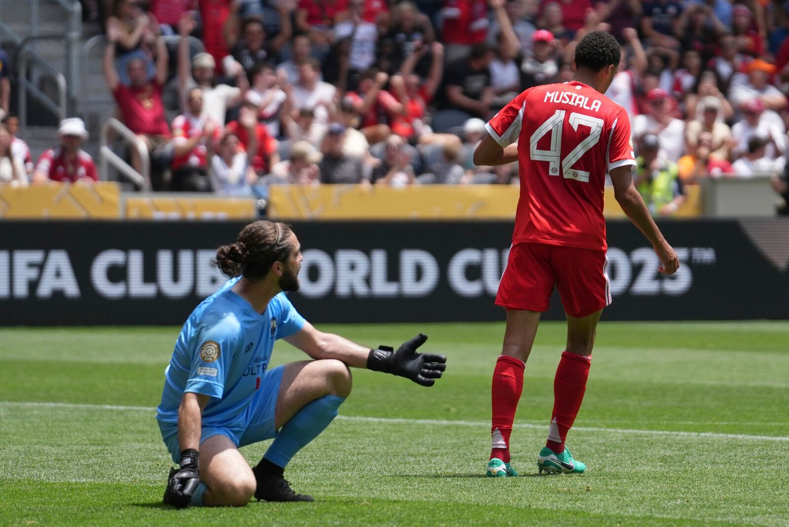 Bayern Munich's Jamal Musiala walks away from Auckland City's Conor Tracey after scoring his side's ninth goal during the Club World Cup group C soccer match between Bayern Munich and Auckland City in Cincinnati, Sunday, June 15, 2025. (AP Photo/Joshua A. Bickel)