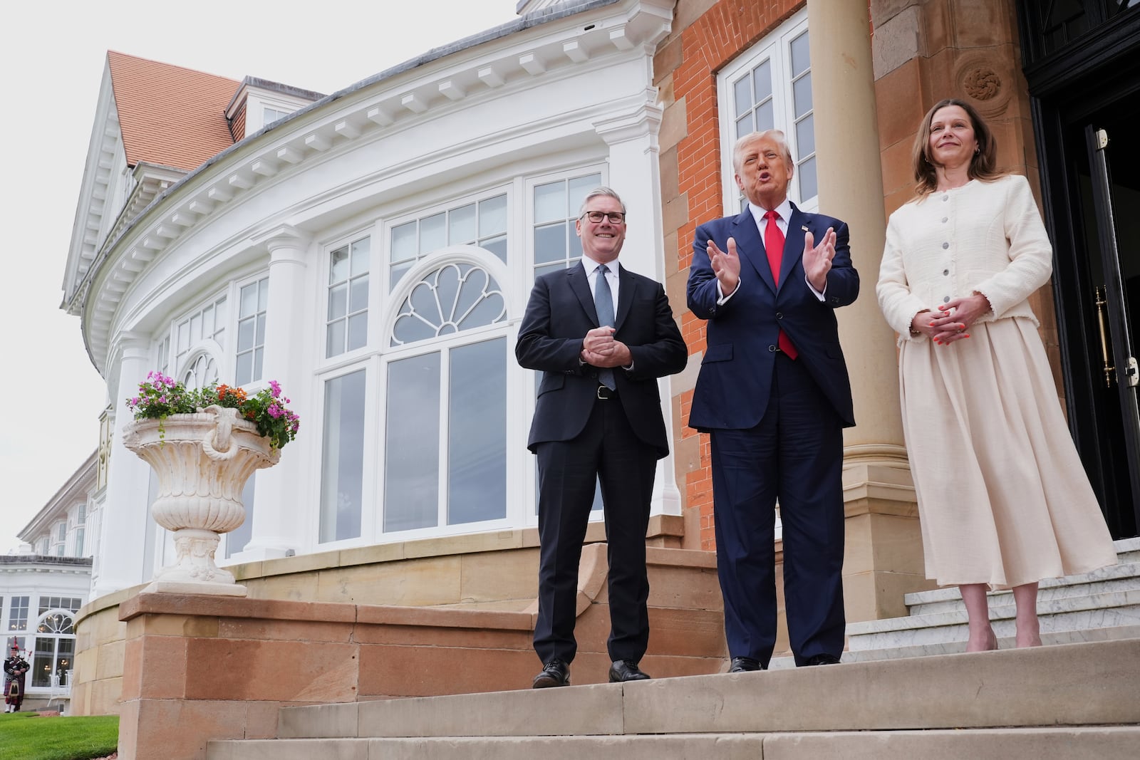 President Donald Trump, center, speaks with the media as he greets Britain's Prime Minister Keir Starmer, left, and his wife Victoria at the Trump Turnberry golf course in Turnberry, Scotland Monday, July 28, 2025. (AP Photo/Jacquelyn Martin)