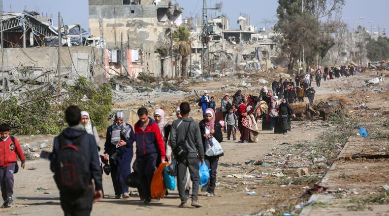 FILE — Displaced Palestinians flee the war between Israel and Hamas in the northern Gaza Strip, walking to its southern section, Nov. 26, 2023. The impact on global economic growth of the violence has so far been contained, but that’s not the case for Israeli neighbors Egypt, Lebanon and Jordan. (Samar Abu Elouf/The New York Times)