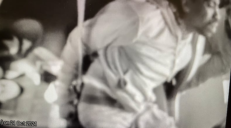 Clifford Owensby is shown by police cruiser cam in back of a Dayton police cruiser after being arrested.