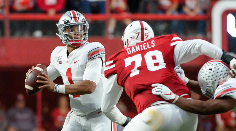LINCOLN, NE - SEPTEMBER 28: Quarterback Justin Fields #1 of the Ohio State Buckeyes passes ahead of the rush from defensive lineman Darrion Daniels #79 of the Nebraska Cornhuskers at Memorial Stadium on September 28, 2019 in Lincoln, Nebraska. (Photo by Steven Branscombe/Getty Images)