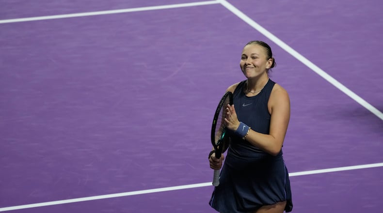 Amanda Anisimova of the United States celebrates after winning her women's singles match against Iga Swiatek of Poland at the WTA tennis finals in Riyadh, Saudi Arabia, Wednesday, Nov. 5, 2025. (AP Photo/Fatima Shbair)