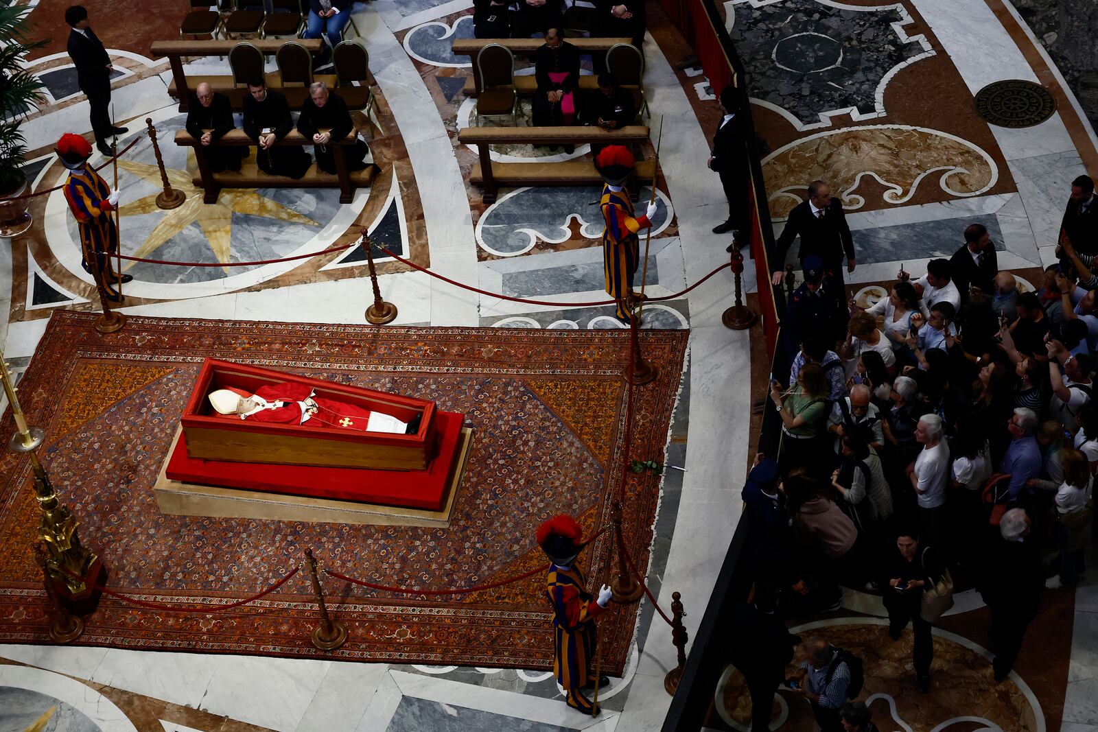 People queue to pay their respect to the late Pope Francis, who will lie in state at St. Peter's Basilica for three days, at the Vatican, Wednesday, April 23, 2025. (Cecilia Fabiano/LaPresse via AP)