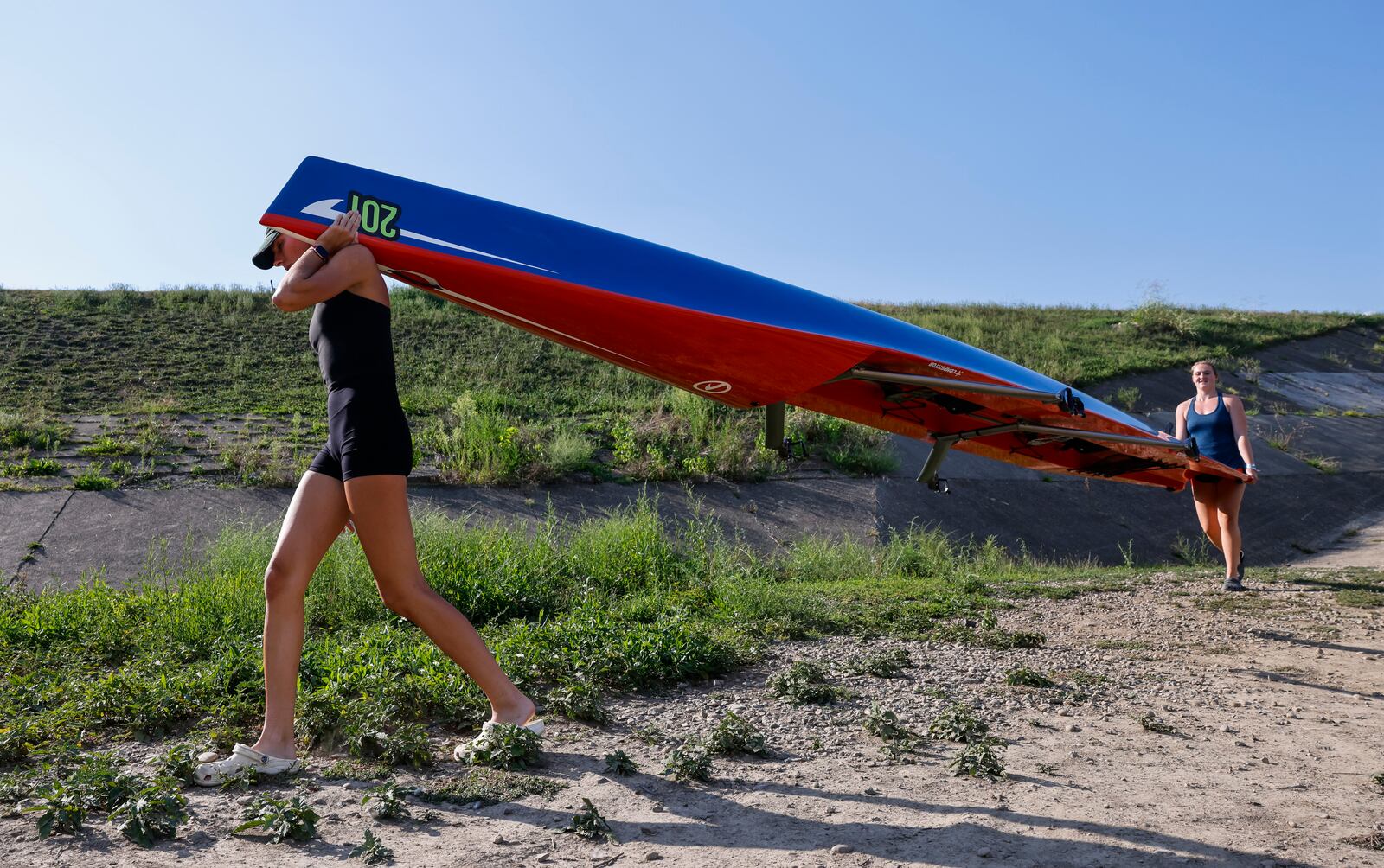 Annalie Duncomb, 16, from Mason, left, and Annelise Hahl, 16, from North Carolina, get ready for practice Thursday, Aug. 25, 2022 in Hamilton. Duncomb, Hahl and others with The Great Miami Rowing Club are heading to Wales where they will be training for and then competing in the 2022 World Coastal Championships and Beach Sprint Finals. NICK GRAHAM/STAFF
