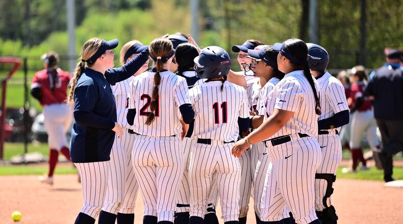 The Dayton softball team huddles during a game against St. Joseph's on April 20, 2024, in Dayton. Photo by Erik Schelkun