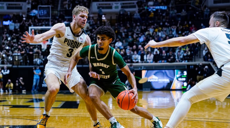 Wright State guard Trey Calvin (1) drives between Purdue forward Caleb Furst (3) and guard Sasha Stefanovic (55) during the first half of an NCAA college basketball game in West Lafayette, Ind., Tuesday, Nov. 16, 2021. (AP Photo/Michael Conroy)