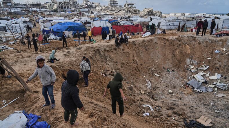 Palestinians inspect the damage at a displacement camp following an Israeli strike in Gaza City, Friday, Jan. 9, 2026. (AP Photo/Jehad Alshrafi)