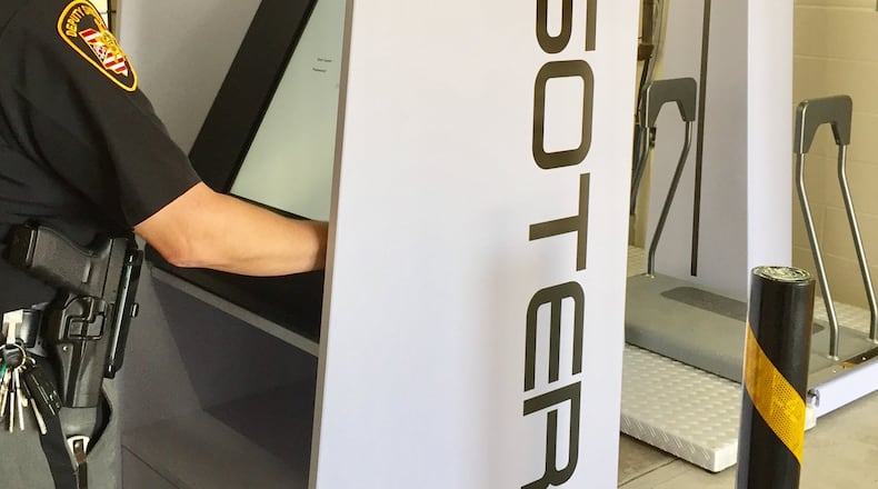 Deputy Capt. Jamie McGlinch of the Miami County Sheriff’s Office trains on a newly installed body scanner at the Miami County Jail. The scanner is located in the Sally port before a prisoner enters the secured area of the jail. Staff is expected to start using the scanners in early October. STEVE BAKER/STAFF