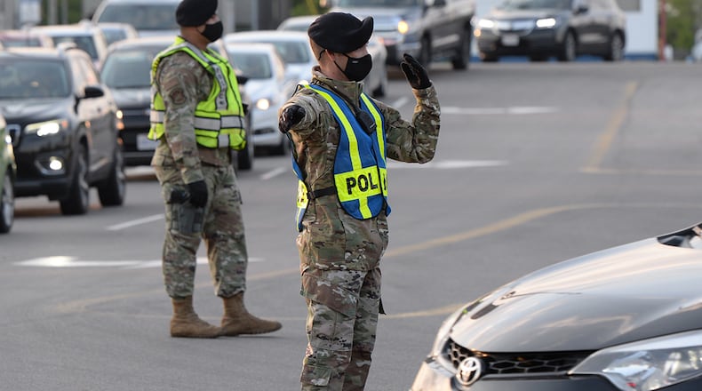 Personnel from the 88th Security Forces Squadron direct traffic entering Gate 12A as it flows through all lanes at Wright-Patterson Air Force Base. U.S. AIR FORCE PHOTO/TY GREENLEES