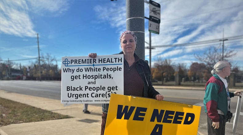 Nancy Kiehl, a member of the Clergy Coalition Community, protests outside of a ceremonial groundbreaking event on Friday, Oct. 28, 2022, for a new facility on the former Good Samaritan Hospital site. CORNELIUS FROLIK / STAFF