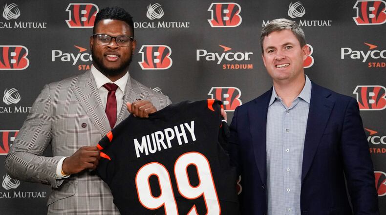 Clemson defensive end Miles Murphy, left, the Cincinnati Bengals' first-round draft pick, poses for a portrait with Cincinnati Bengals head coach Zac Taylor, right, during a news conference, Saturday, April 29, 2023, in Cincinnati. (AP Photo/Joshua A. Bickel)