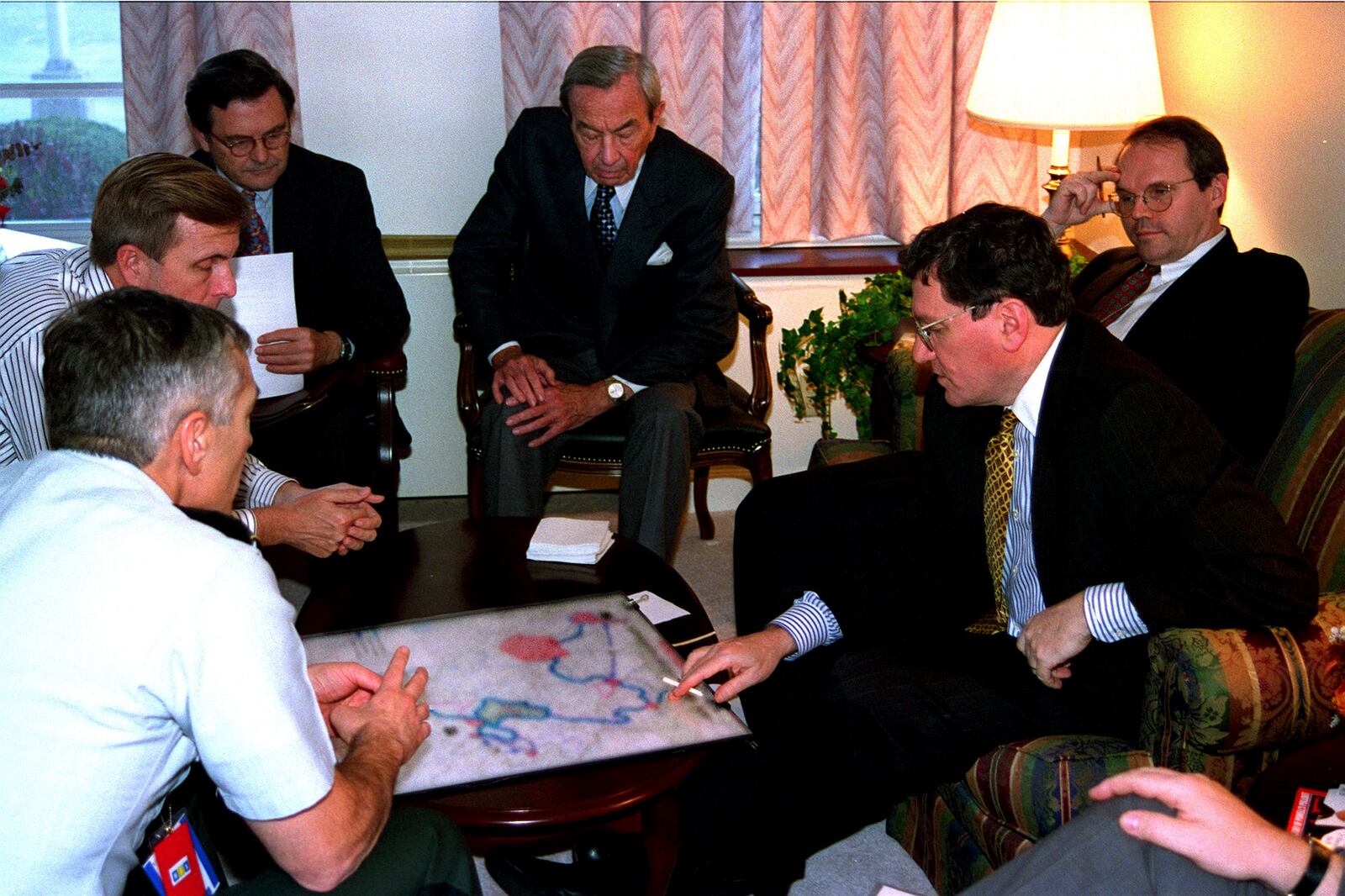 Secretary of State Warren Christopher (center at rear), Assistant Secretary of State Richard Holbrooke (right) and then Lt. Gen. Wesley Clark (left) and others confer during the Bosnian peace talks held for three weeks at Wright-Patterson Air Force Base in Nov. 1995. PHOTO COURTESY OF THE UNITED STATES AIR FORCE