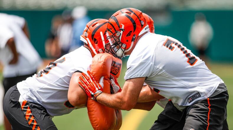 Cincinnati Bengals offensive tackle Andrew Whitworth, right, and guard Alex Cooper make contact during a drill on the first day of mandatory mini camp Tuesday, June 14 at Paul Brown Stadium in Cincinnati. NICK GRAHAM/STAFF