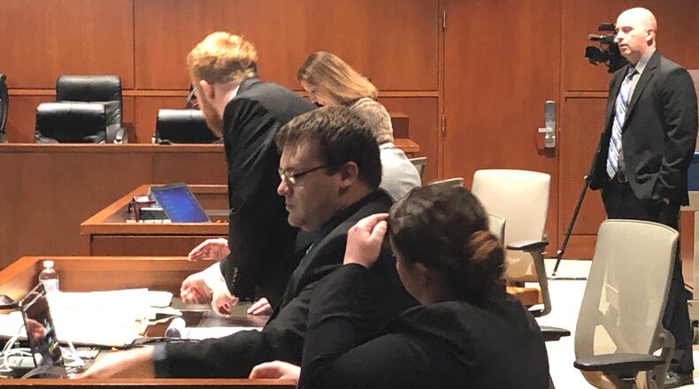 John Austin Hopkins and his lawyers prepare for trial Tuesday afternoon in Warren County Common Pleas Court. STAFF/LAWRENCE BUDD