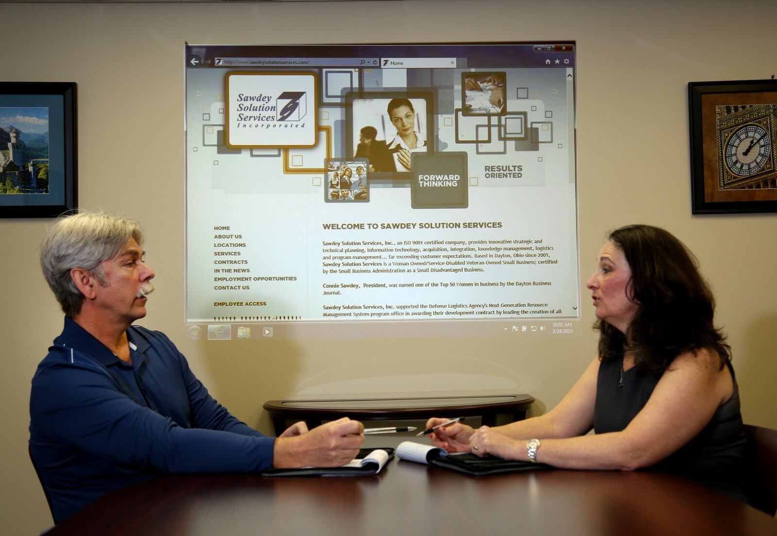 Co-owners Jeff and Connie Sawdey meet at the Sawdey Solution Services office conference room in Beavercreek. The company has landed five Air Force Research Laboratory contracts in three years. FILE