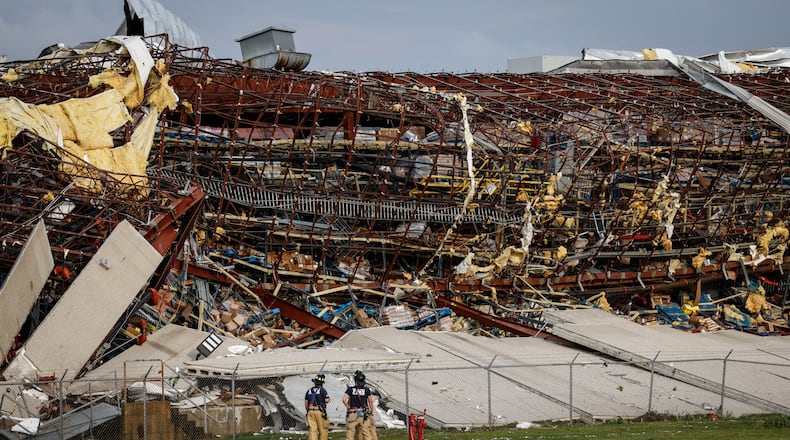Firefighters are shown near the damage at the Meijer Distribution Center in Tipp City near Interstate 75 after a tornado struck the area on Wednesday, June 8, 2022. JIM NOELKER/STAFF