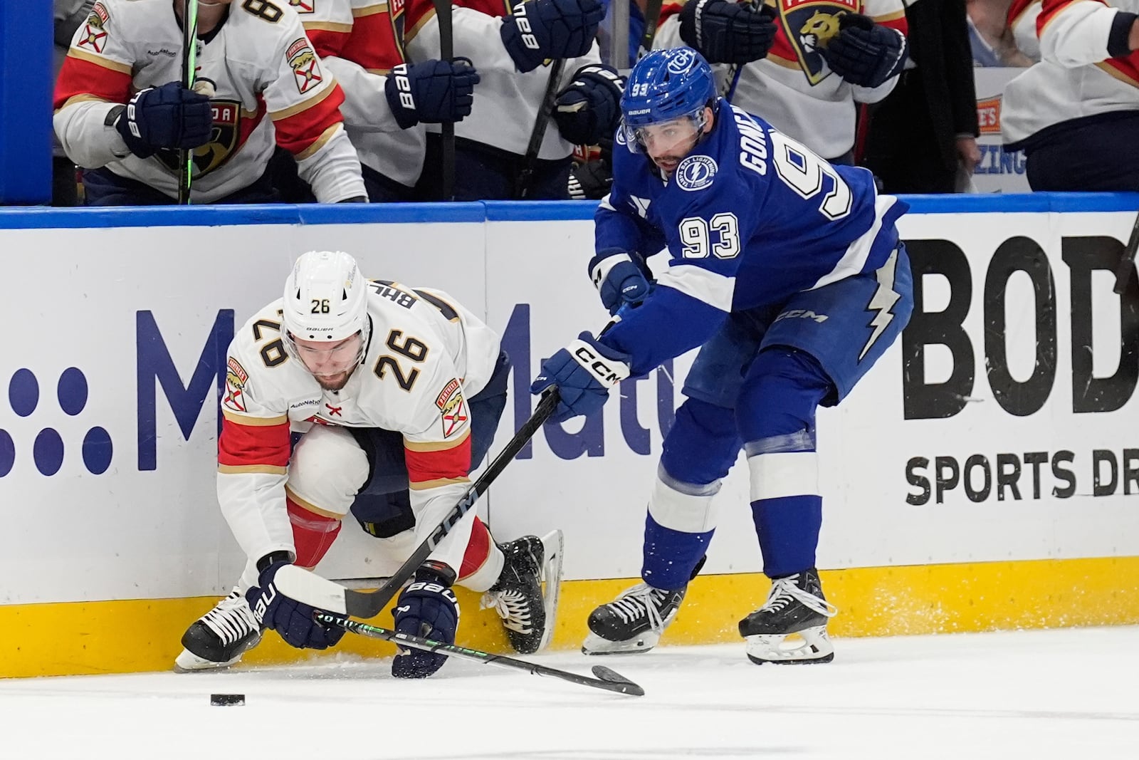 Tampa Bay Lightning center Gage Goncalves (93) takes down Florida Panthers defenseman Uvis Balinskis (26) during the first period in Game 5 of an NHL hockey Stanley Cup first-round playoff series, Wednesday, April 30, 2025, in Tampa, Fla. (AP Photo/Chris O'Meara)