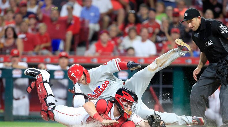 CINCINNATI, OH - JULY 26: Tucker Barnhart #16 of the Cincinnati Reds tags out Scott Kingery #4 of the Philadelphia Phillies at home plate in the fifth inning at Great American Ball Park on July 26, 2018 in Cincinnati, Ohio. (Photo by Andy Lyons/Getty Images)