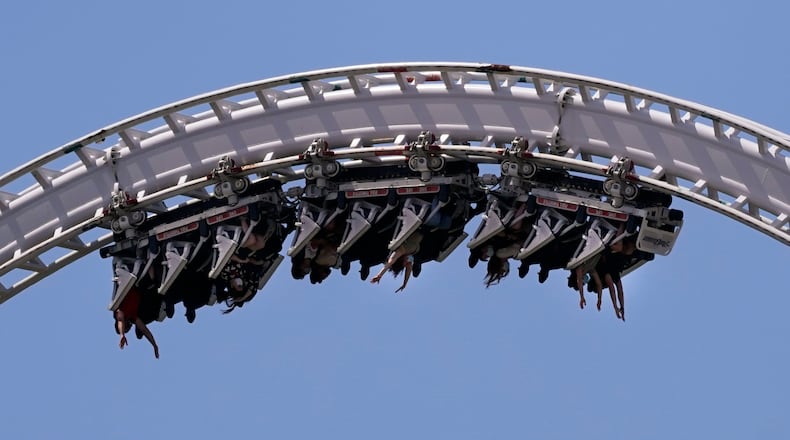 FILE - Visitors ride a roller coaster at Six Flags Magic Mountain in Valencia, Calif., April 1, 2021. (AP Photo/Jae C. Hong, File)