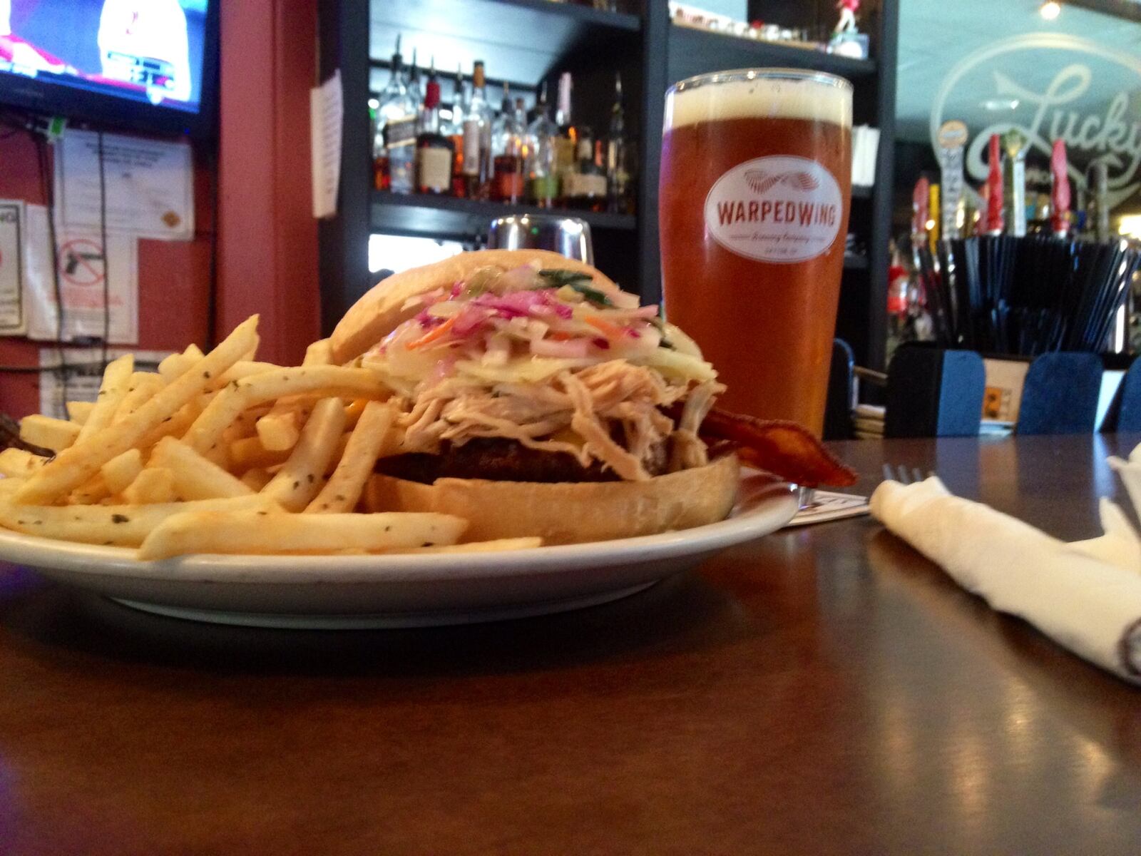 The Hearse Burger at Lucky's taproom in Dayton's Oregon District includes ground steak from Keener Farms near Dayton, cheddar and pepper jack cheese, applewood smoked bacon, red cabbage slaw and  pulled chicken that has been braised in Warped Wing's Flyin' Ale. (Photo by Amelia Robinson)