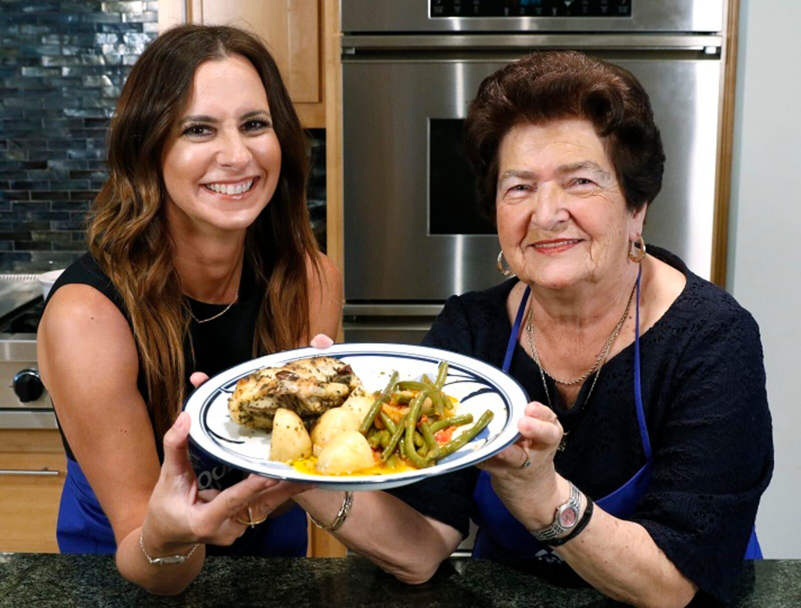 The finished classic Greek lemon chicken and potatoes and Greek green beans prepared by Christina Moros and her grandmother, Christina Zarras in the home of Maria Beys in Dallas on Wednesday, Sept. 13, 2017. (David Woo/The Dallas Morning News/TNS) NO MAGAZINE SALES MANDATORY CREDIT; NO SALES; INTERNET USE BY TNS CONTRIBUTORS ONLY