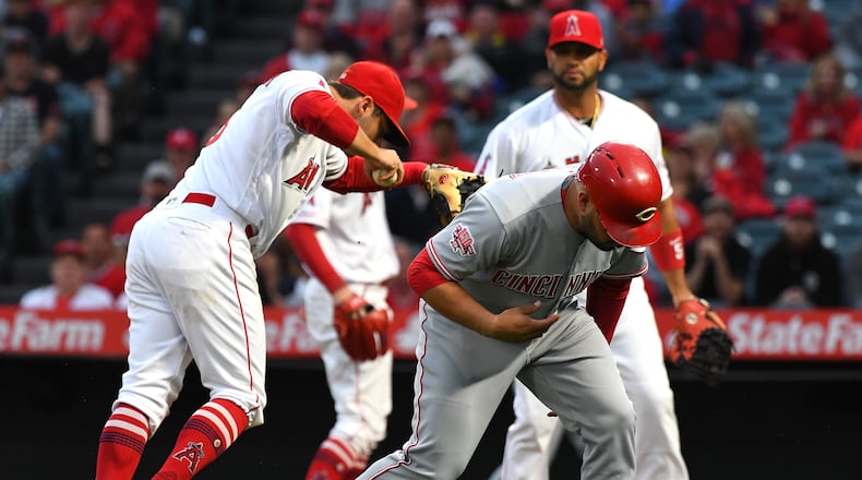ANAHEIM, CA - JUNE 25: Eugenio Suarez #7 of the Cincinnati Reds is tagged out in a run down play by David Fletcher #6 of the Los Angeles in the first inning at Angel Stadium of Anaheim on June 25, 2019 in Anaheim, California. (Photo by Jayne Kamin-Oncea/Getty Images)