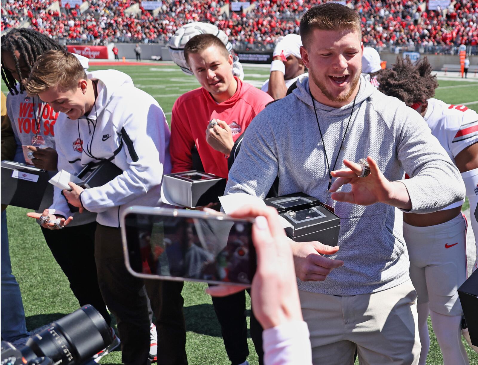 Ohio State's Will Howard, left, and Jack Sawyer, righ admire their NCAA college football championship rings during the school's spring football game, Saturday, April 12,2 025, in Columbus, Ohio. (David Petkiewicz/Cleveland.com via AP)