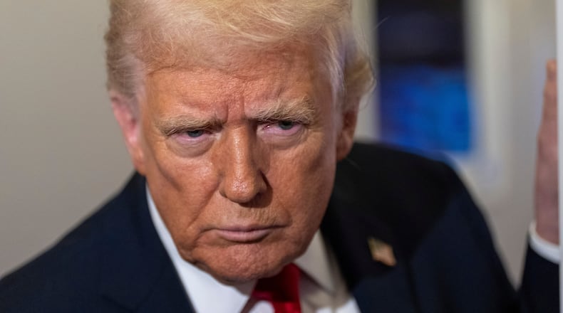 President Donald Trump leans in to hear a question as he speaks with reporters while in flight on Air Force One from Joint Base Andrews to his Mar-a-Lago estate in Palm Beach, Fla., Tuesday, Nov. 25, 2025. (AP Photo/Alex Brandon)